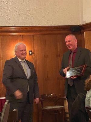 Howard Wicker accepting his plaque of recognition