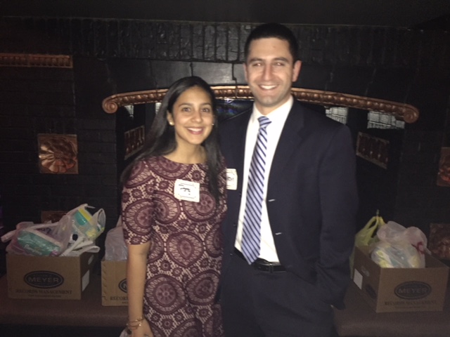 (L to R) YLS Real Estate and Property Law Committee Chair  Patricia (Paty) Jimenez and YLS member Justin Durelli  with collected donations for the two organizations.